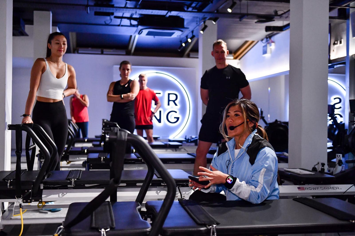 Chou Lim (STRONG Studio Owner) teaching students on a Pilates reformer in her ‘STRONG’ Islington Studio.