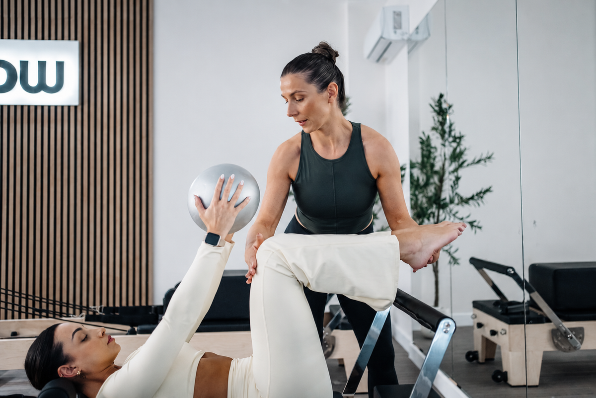 Diana Coffey teaching a client with a small ball.